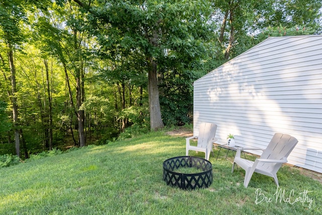 68 E River Rd, Muskegon, MI 49445 - view of grassy yard featuring an outdoor fire pit