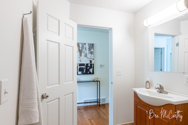 68 E River Rd, Muskegon, MI 49445 - bathroom featuring vanity and wood finished floors