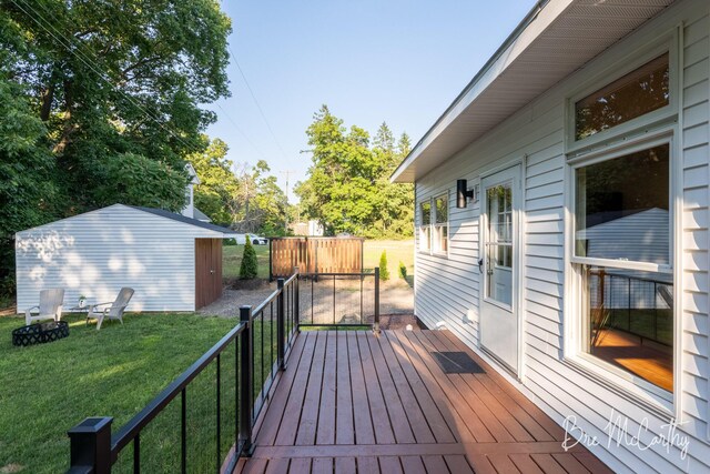 68 E River Rd, Muskegon, MI 49445 - deck featuring a yard, a storage shed, and an outdoor fire pit