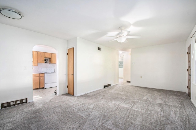 157 Elvern Dr, Coloma, MI 49038 - unfurnished living room featuring a ceiling fan, light carpet, and arched walkways