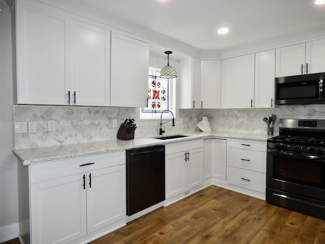 630 Forest St, Wyandotte, MI 48192 - kitchen with black appliances, white cabinetry, light stone countertops, dark wood-style floors, and recessed lighting