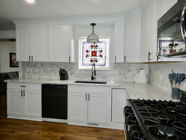 630 Forest St, Wyandotte, MI 48192 - kitchen with stainless steel microwave, black dishwasher, gas stove, white cabinets, and light stone counters