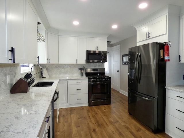 630 Forest St, Wyandotte, MI 48192 - kitchen featuring freestanding refrigerator, stainless steel microwave, gas range, tasteful backsplash, and recessed lighting