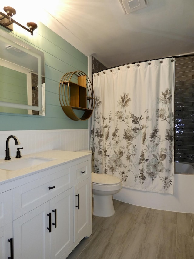 630 Forest St, Wyandotte, MI 48192 - bathroom featuring vanity, wood finished floors, shower / bath combination with curtain, wood walls, and wainscoting