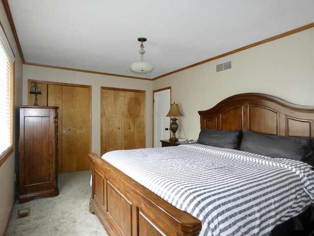 630 Forest St, Wyandotte, MI 48192 - bedroom featuring light colored carpet, two closets, and ornamental molding