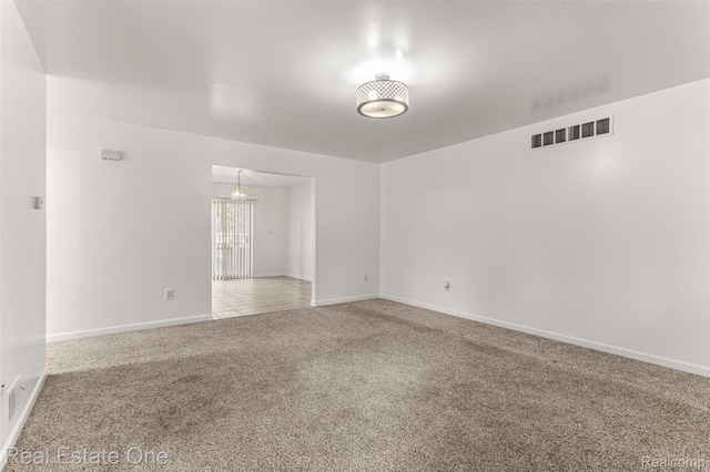 1625 Ferney St, Dearborn Heights, MI 48120 - empty room with carpet floors and a chandelier