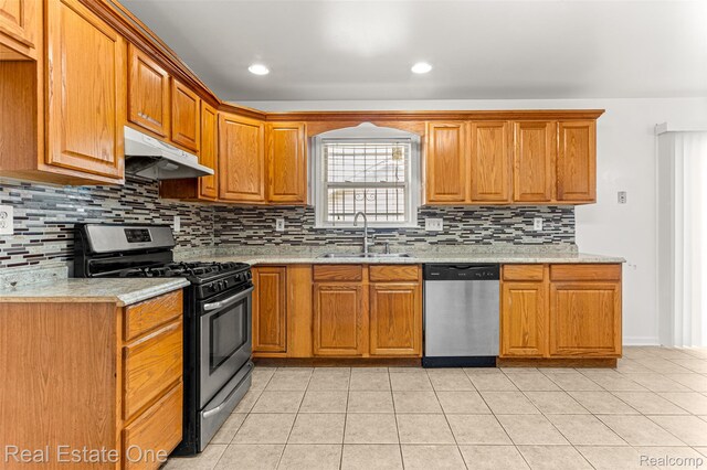 1625 Ferney St, Dearborn Heights, MI 48120 - kitchen featuring appliances with stainless steel finishes, under cabinet range hood, tasteful backsplash, light tile patterned floors, and recessed lighting