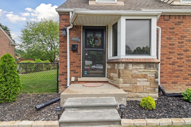 15404 Belmont Ave, Allen Park, MI 48101 - view of exterior entry featuring roof with shingles, stone siding, and brick siding