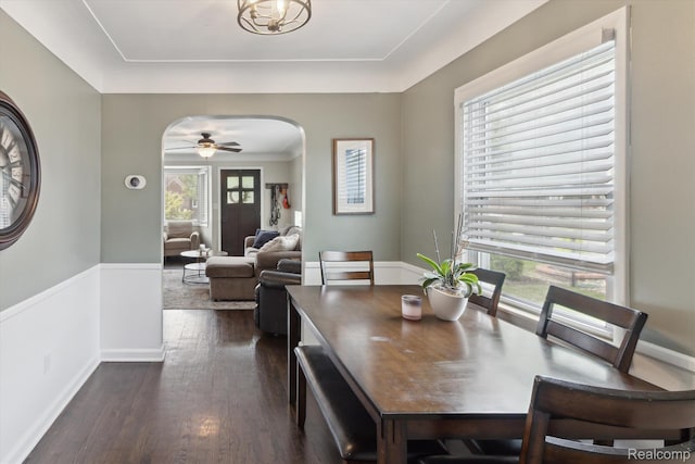 15404 Belmont Ave, Allen Park, MI 48101 - dining area with arched walkways, dark wood-style flooring, a wainscoted wall, and a ceiling fan
