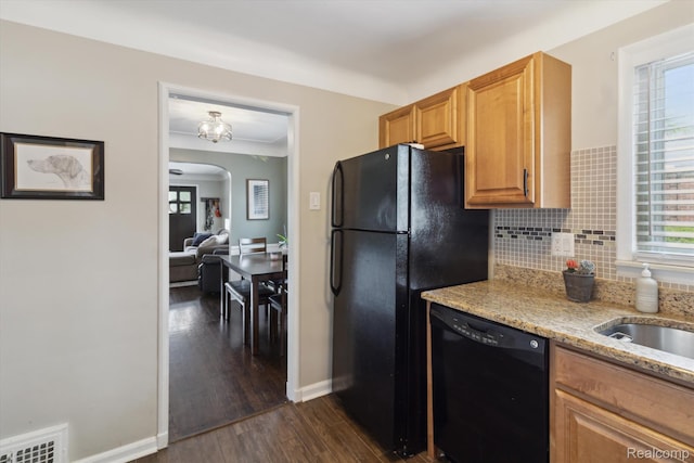 15404 Belmont Ave, Allen Park, MI 48101 - kitchen with black appliances, arched walkways, light stone countertops, dark wood-style flooring, and tasteful backsplash