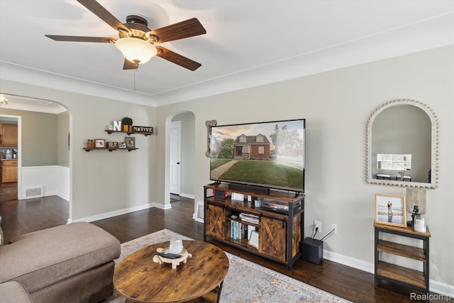 15404 Belmont Ave, Allen Park, MI 48101 - living area with arched walkways, dark wood-style floors, and a ceiling fan