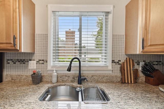 15404 Belmont Ave, Allen Park, MI 48101 - kitchen with backsplash, plenty of natural light, and light stone countertops