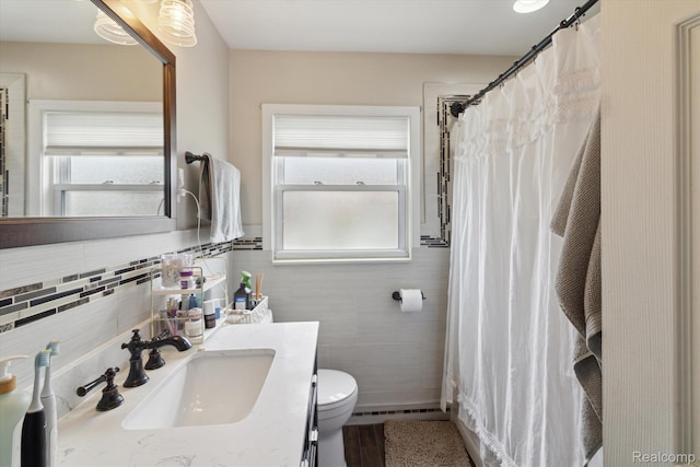 15404 Belmont Ave, Allen Park, MI 48101 - bathroom with tile walls, healthy amount of natural light, vanity, and a shower with shower curtain