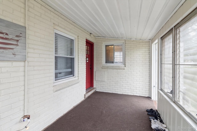 15404 Belmont Ave, Allen Park, MI 48101 - unfurnished sunroom with brick wall and carpet flooring