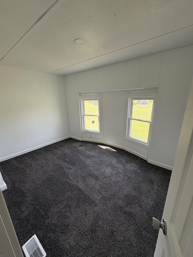 2835 E Sessions Rd, Sheridan, MI 48884 - spare room featuring dark colored carpet and baseboards