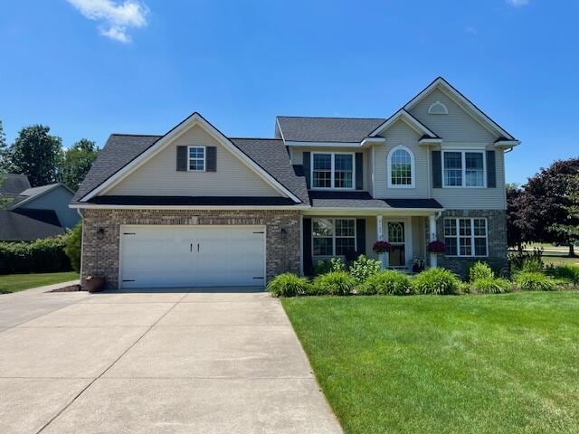 9107 Lady Lauren Dr NE, Rockford, MI 49341 - view of front of house with concrete driveway, a front lawn, and a garage