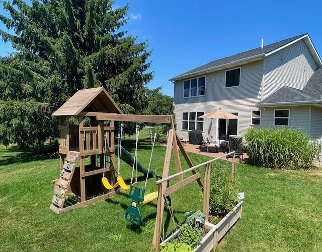 9107 Lady Lauren Dr NE, Rockford, MI 49341 - view of playground with a lawn