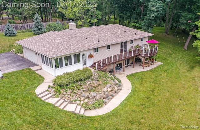 5074 Perryville Rd, Holly, MI 48442 - rear view of house featuring stairway, a wooden deck, a shingled roof, a chimney, and a lawn