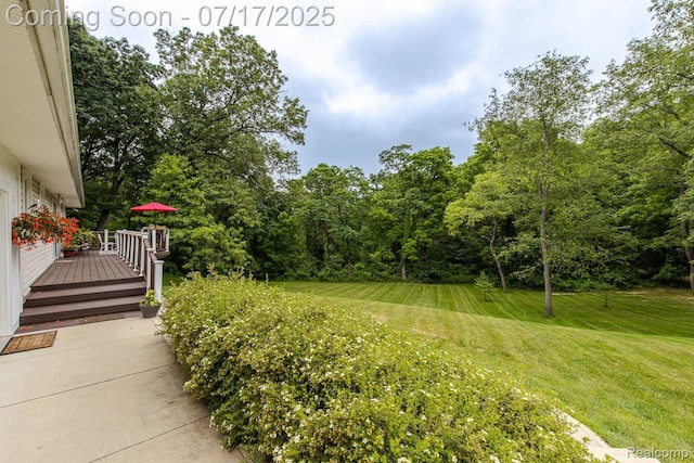 5074 Perryville Rd, Holly, MI 48442 - view of green lawn with a deck
