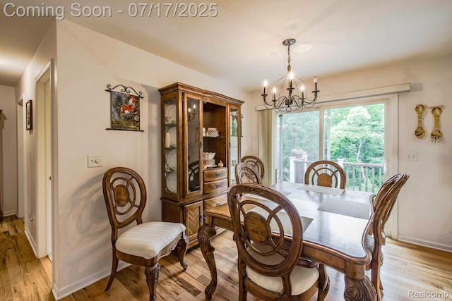 5074 Perryville Rd, Holly, MI 48442 - dining area with a chandelier and light wood-style floors