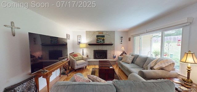 5074 Perryville Rd, Holly, MI 48442 - living room with a brick fireplace and wood finished floors