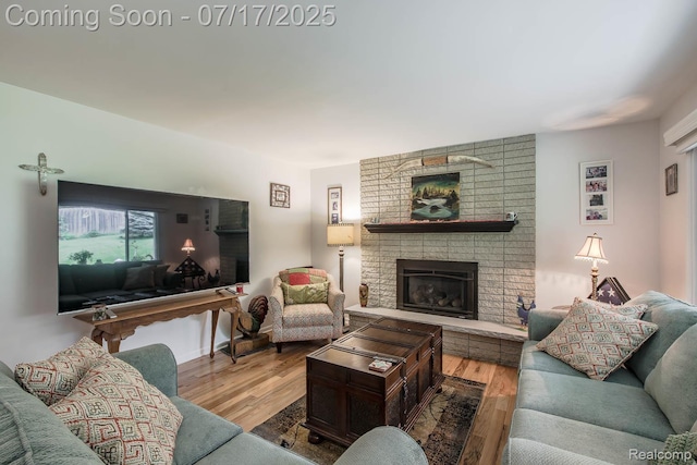 5074 Perryville Rd, Holly, MI 48442 - living room featuring wood finished floors and a fireplace