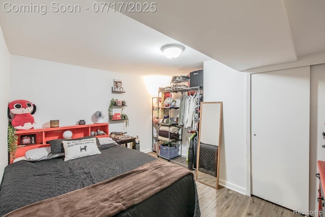 5074 Perryville Rd, Holly, MI 48442 - bedroom featuring wood finished floors and a closet