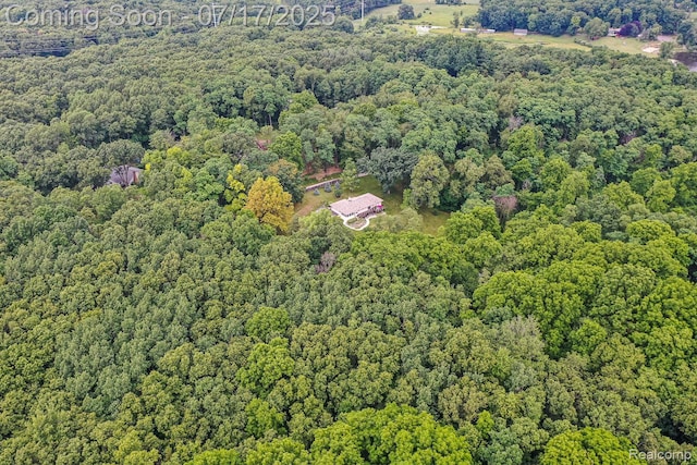 5074 Perryville Rd, Holly, MI 48442 - aerial overview of property's location featuring a heavily wooded area