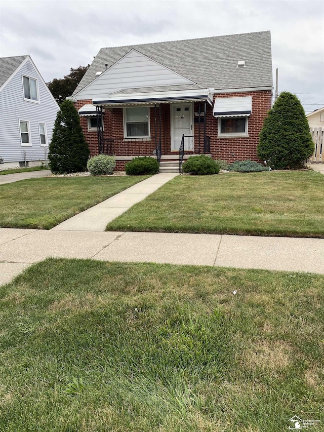 3897 15th St, Wyandotte, MI 48192 - bungalow-style home featuring brick siding, a front yard, roof with shingles, and covered porch