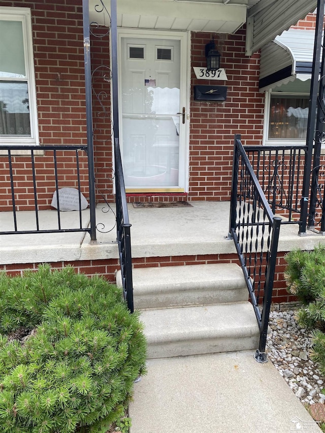 3897 15th St, Wyandotte, MI 48192 - property entrance with brick siding and a porch