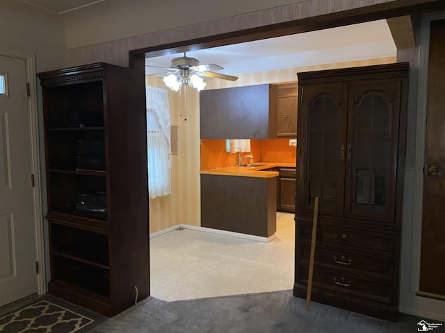 3897 15th St, Wyandotte, MI 48192 - kitchen featuring a ceiling fan, light countertops, and light colored carpet