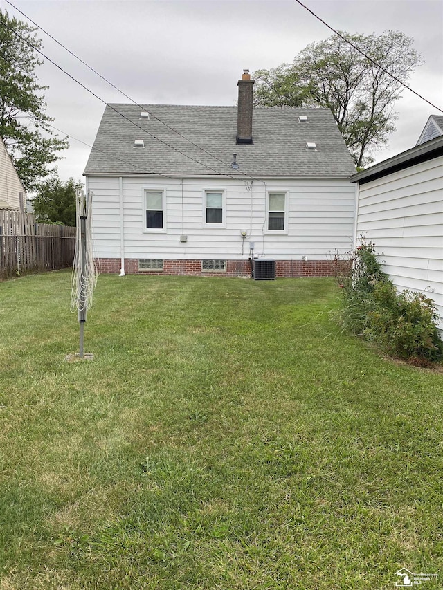 3897 15th St, Wyandotte, MI 48192 - back of house with a shingled roof and a chimney