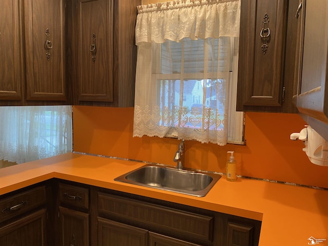 3897 15th St, Wyandotte, MI 48192 - kitchen with dark brown cabinets and light countertops