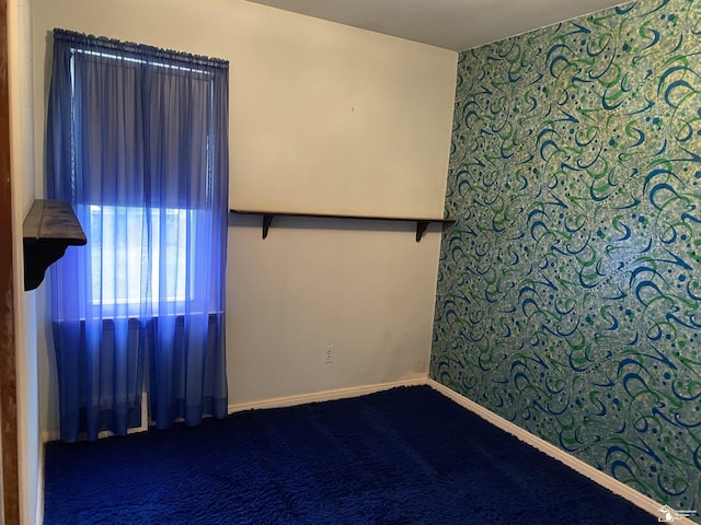 3897 15th St, Wyandotte, MI 48192 - unfurnished room with dark colored carpet and wallpapered walls