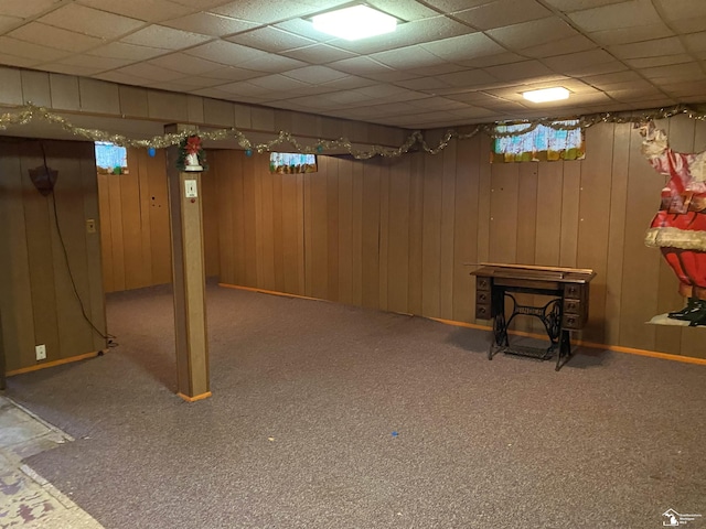 3897 15th St, Wyandotte, MI 48192 - finished below grade area featuring a wood stove, carpet floors, a drop ceiling, and wooden walls