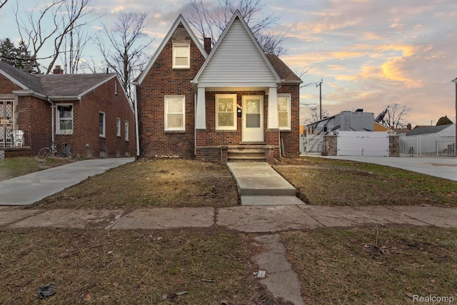 8131 Coyle St, Detroit, MI 48228 - bungalow-style home with brick siding and a gate