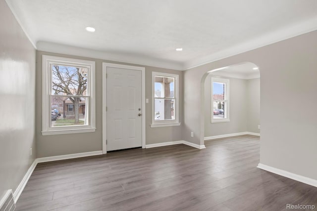 8131 Coyle St, Detroit, MI 48228 - entryway with arched walkways, plenty of natural light, ornamental molding, dark wood-style flooring, and recessed lighting