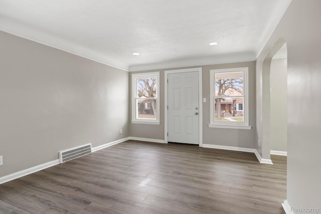 8131 Coyle St, Detroit, MI 48228 - entryway featuring healthy amount of natural light, arched walkways, dark wood-type flooring, ornamental molding, and recessed lighting