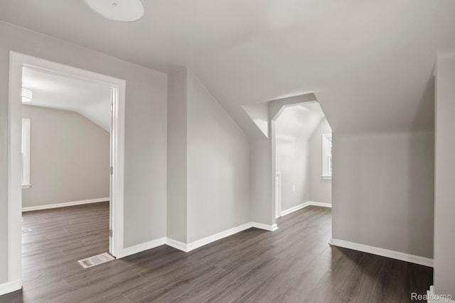 8131 Coyle St, Detroit, MI 48228 - additional living space featuring vaulted ceiling and dark wood-style flooring