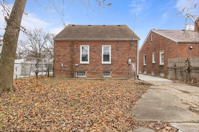 8131 Coyle St, Detroit, MI 48228 - back of house featuring brick siding and a shingled roof