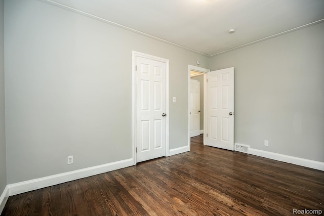17344 Wisconsin St, Detroit, MI 48221 - unfurnished bedroom featuring dark wood finished floors and ornamental molding