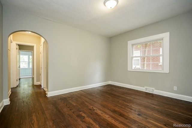 17344 Wisconsin St, Detroit, MI 48221 - spare room with arched walkways and dark wood-type flooring