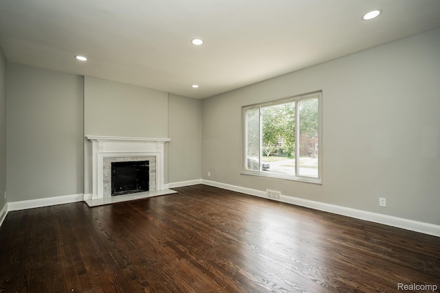17344 Wisconsin St, Detroit, MI 48221 - unfurnished living room featuring wood finished floors, a fireplace with flush hearth, and recessed lighting