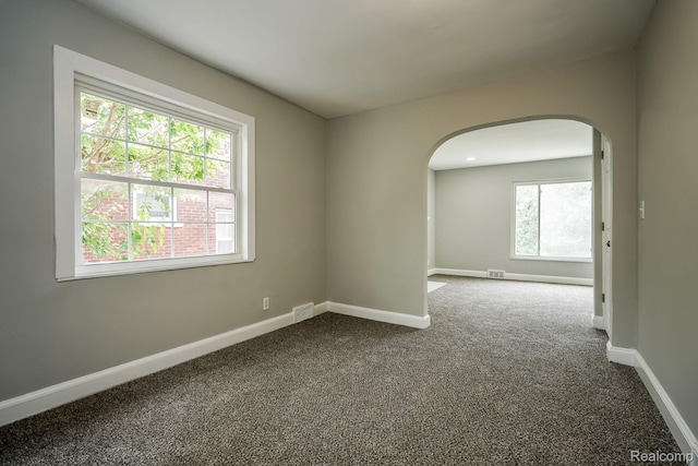 17344 Wisconsin St, Detroit, MI 48221 - empty room featuring arched walkways and dark carpet