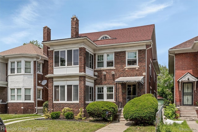 1536 Glynn Ct, Detroit, MI 48206 - rear view of house featuring brick siding and a chimney