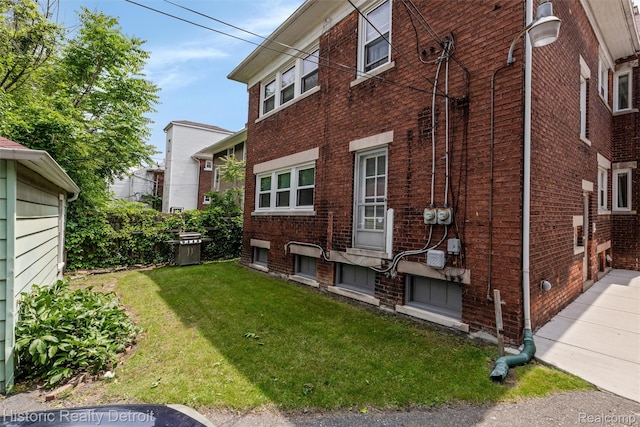 1536 Glynn Ct, Detroit, MI 48206 - view of home's exterior with brick siding and a lawn
