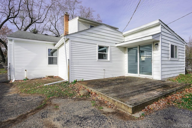 967 Keith St, Oxford, MI 48371 - rear view of property with a deck and a chimney