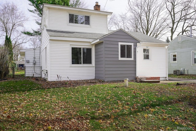 967 Keith St, Oxford, MI 48371 - rear view of property with a chimney and a shingled roof