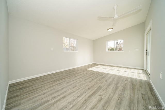 967 Keith St, Oxford, MI 48371 - empty room with light wood finished floors, lofted ceiling, healthy amount of natural light, and a ceiling fan