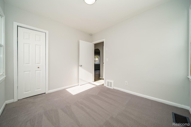 967 Keith St, Oxford, MI 48371 - unfurnished bedroom featuring carpet and arched walkways